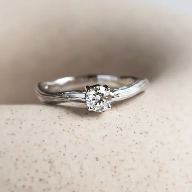 Atypical engagement ring with diamond and tree bark surface RIA Image