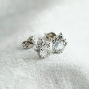 Angled view of MONY gold earrings with moonstone and diamonds