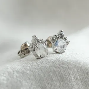 Close-up angled view of MONY gold earrings with moonstone and diamonds
