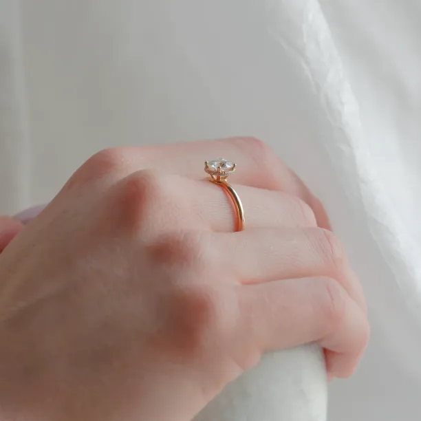 Side view of the ISABELLA diamond engagement ring worn on a hand