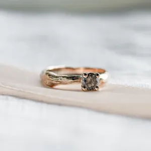 Close-up of the twig-shaped ring and its salt and pepper diamond