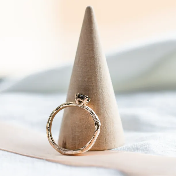 Side view of the twig-shaped ring showing the diamond setting
