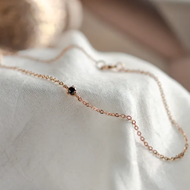 DUNCAN gold bracelet with a black diamond, shown in close-up