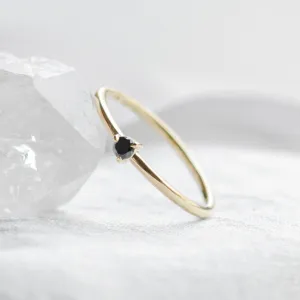 DUNCAN gold ring with a black diamond in an angled view