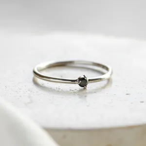 Minimalist gold ring with a black diamond