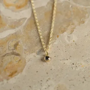 Close-up of the DARCY gold necklace and black diamond pendant