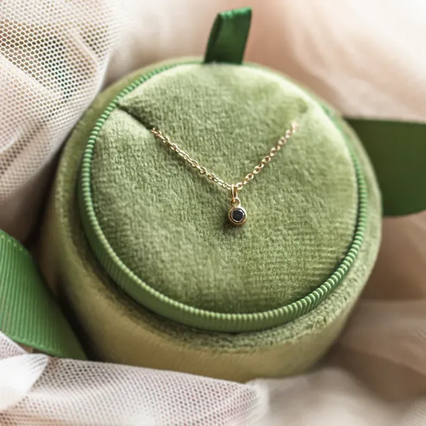 DARCY gold necklace with a black diamond pendant in close-up