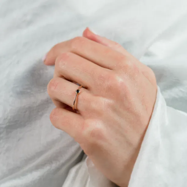 DARCY gold ring with a black diamond worn on a hand