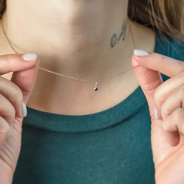DARCY gold necklace with a black diamond worn around the neck