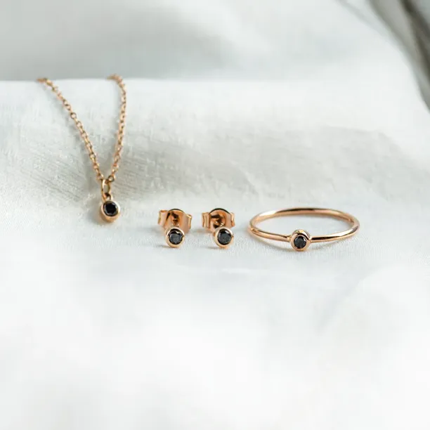 DARCY gold jewelry collection with black diamond ring, necklace and earrings
