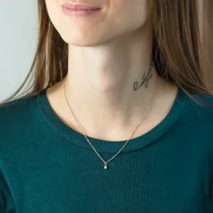 BLAKELEY gold bezel necklace with black diamond worn on the neck