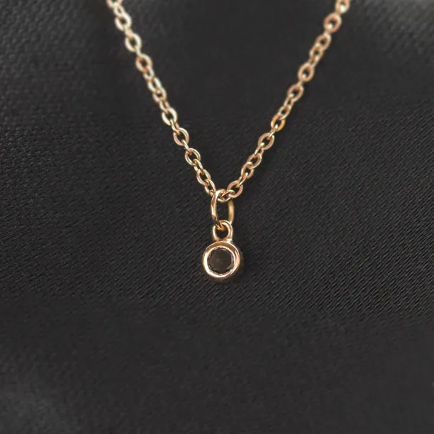 Close-up of the gold bezel pendant with black diamond