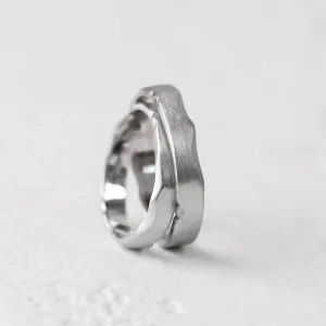 Close-up of DANTE gold wedding bands showing their irregular edges