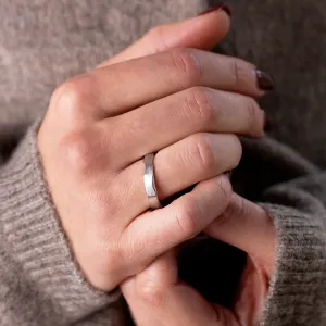 DANTE gold wedding band with a torn paper edge worn on the hand