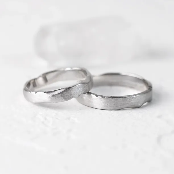 DANTE torn paper edge gold wedding bands shown together