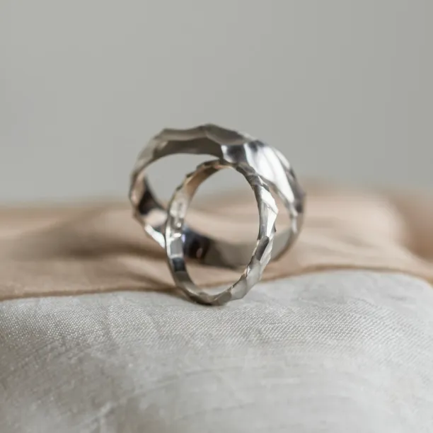 Angled view of a pair of original engraved wedding rings ROCK