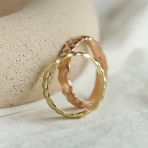 Angled view of original ROCK wedding rings with textured engraved surfaces