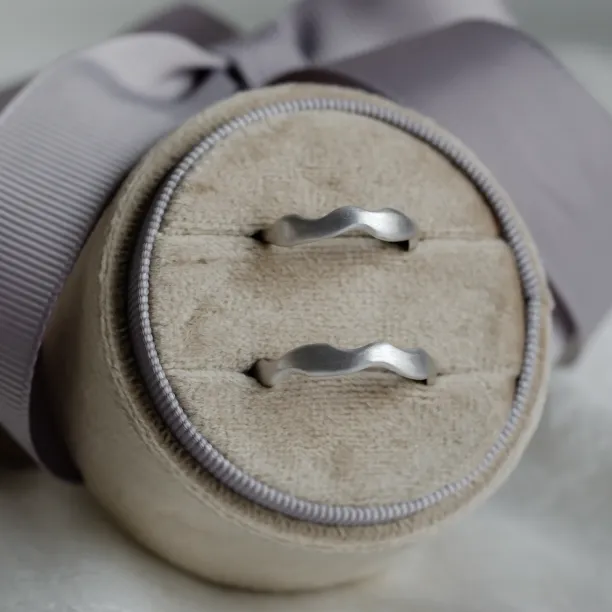Pair of GOCCIO unusual wedding rings with irregular curved bands