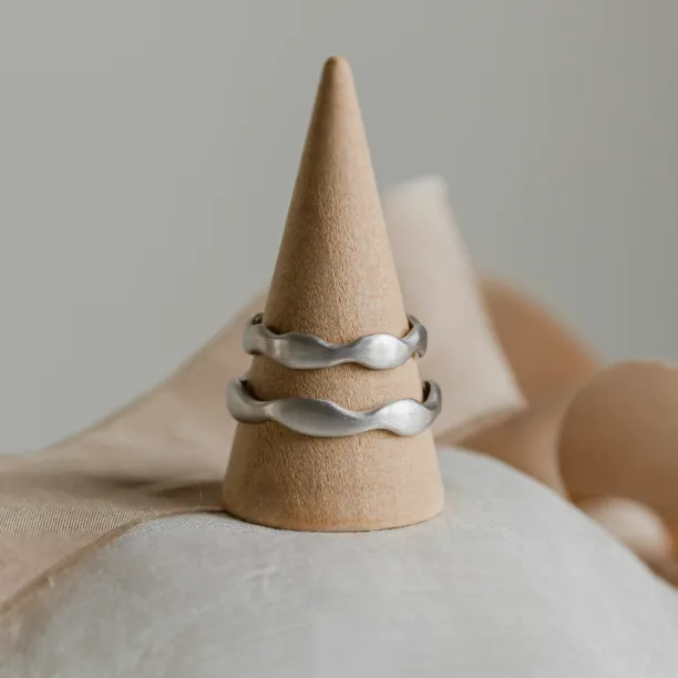 GOCCIO pair of unusual wedding rings displayed to show their irregular shape