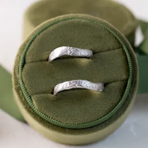 Two MUSK irregular gold wedding bands shown from above