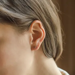 Close-up of an ANISE salt and pepper diamond earring worn on the ear