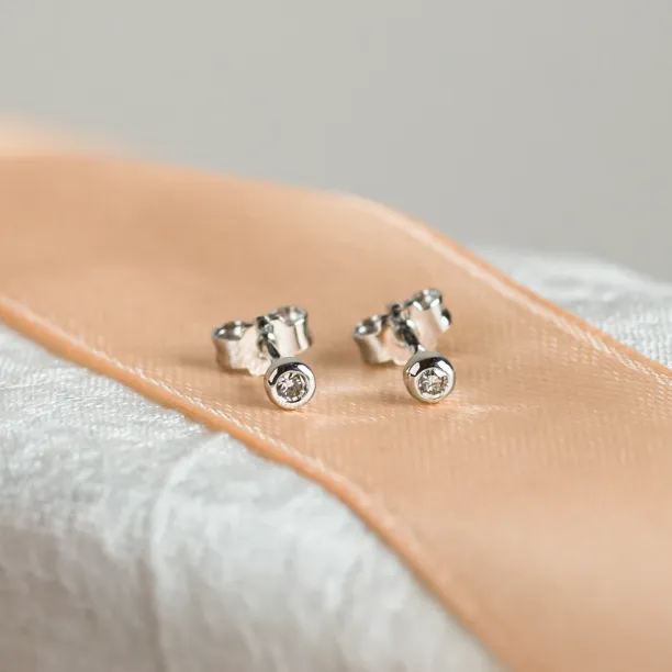 Pair of ANISE salt and pepper diamond earrings, shown from an angled view