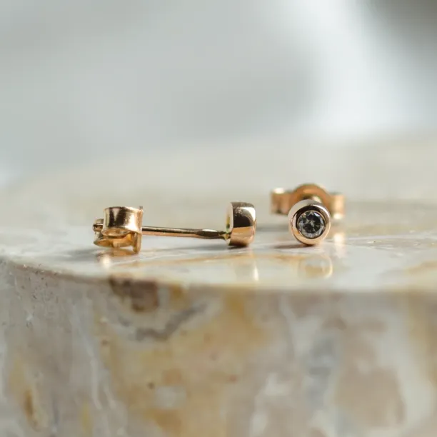 Close-up of ANISE salt and pepper diamond earrings showing the posts and backs