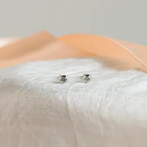 Front close-up of ANISE minimalist salt and pepper diamond earrings
