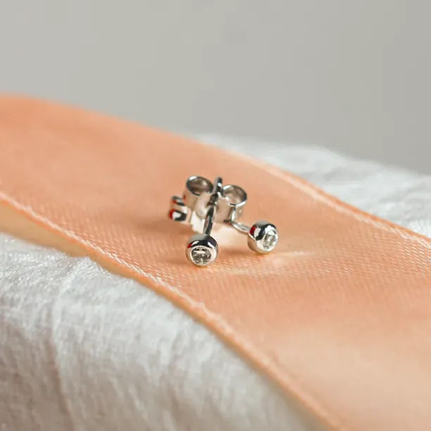 Angled view of ANISE salt and pepper diamond earrings showing the backs