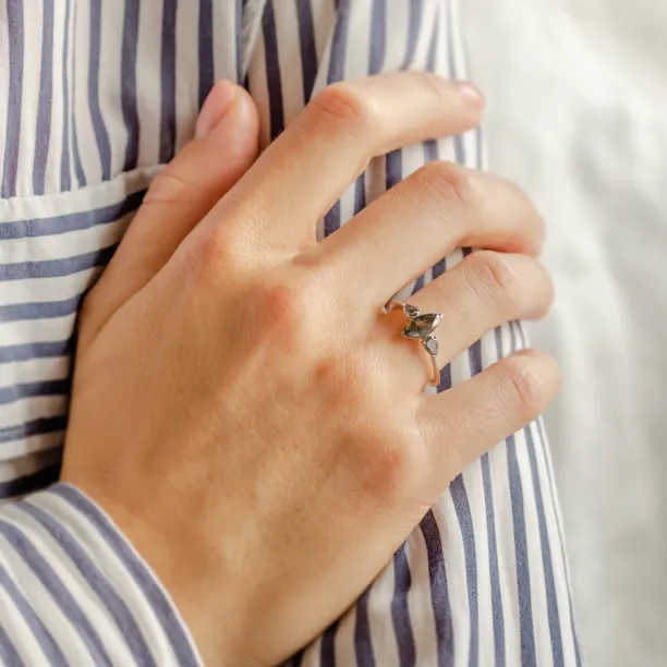 RHEA vintage engagement ring with salt and pepper diamonds worn on a hand