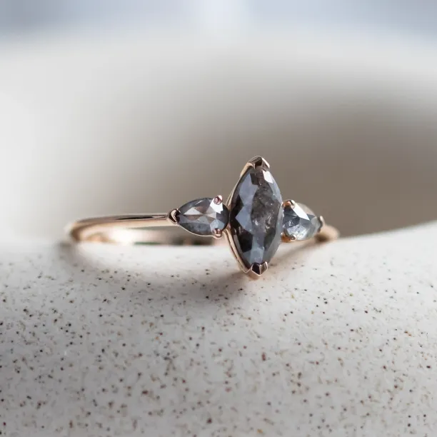 Angled close-up of the RHEA ring with a marquise and two pear-shaped diamonds