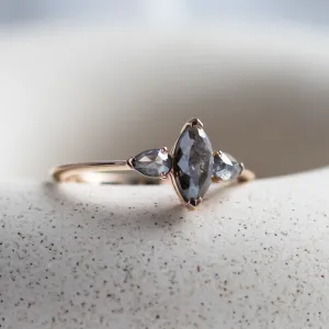 Angled close-up of the RHEA ring with a marquise and two pear-shaped diamonds