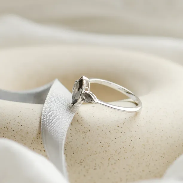 Angled view of RHEA gold engagement ring with three salt and pepper diamonds
