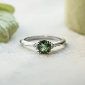 Moss agate engagement ring with diamonds in a clear front view