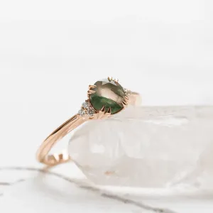 Angled close-up of the moss agate and diamond engagement ring
