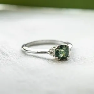 Angled view of the moss agate and diamond engagement ring