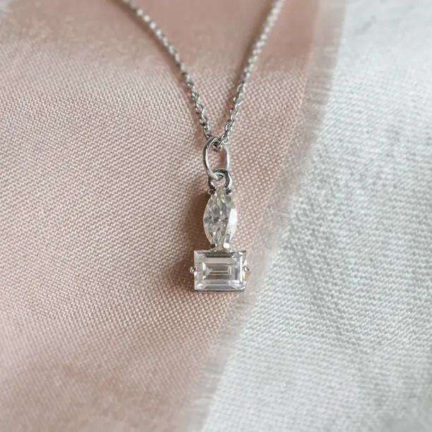 Close-up of the LYON necklace pendant with marquise and baguette moissanites