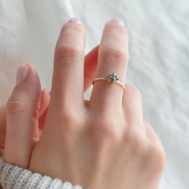 Close-up of the DAF ring with salt and pepper diamonds worn on a finger