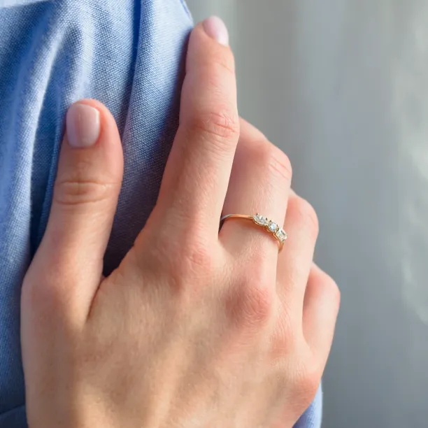 Gold AVERY ring with three moissanites worn on the hand