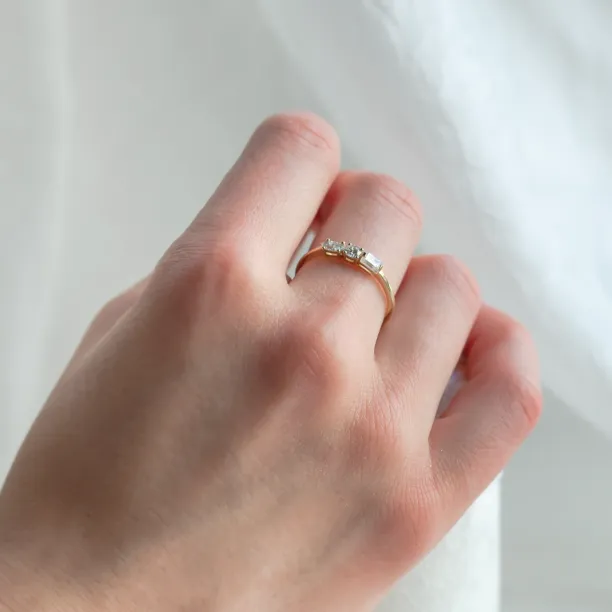 Angled view of the gold AVERY ring worn on the hand