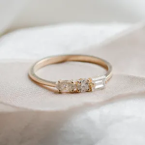 Gold ring with baguette, round and marquise moissanites in a close-up view