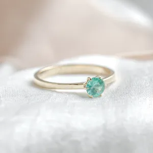 Angled view of the gold engagement ring with emerald JADE