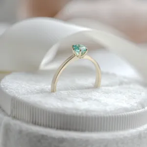 JADE gold engagement ring with emerald, angled view of the raised setting
