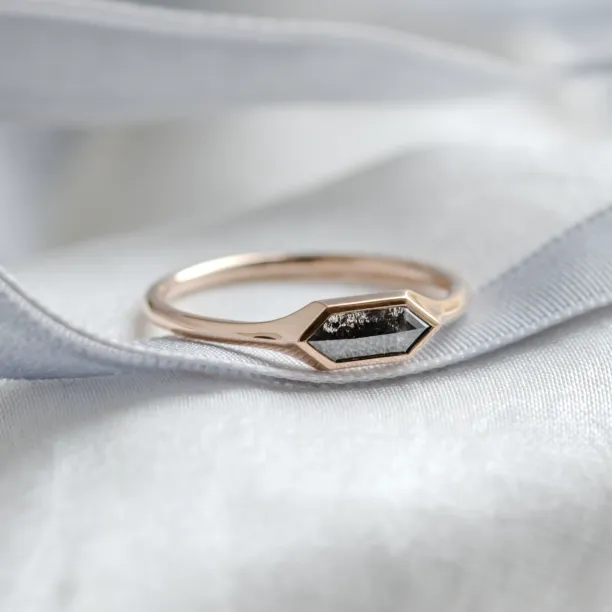 Angled close-up of the gold hexagon salt and pepper diamond ring