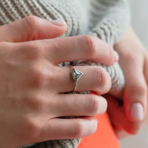 HERO gold ring with a superman salt and pepper diamond worn on the hand