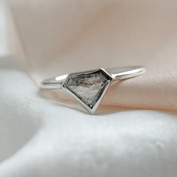 Close-up of the geometric HERO gold ring with a superman salt and pepper diamond