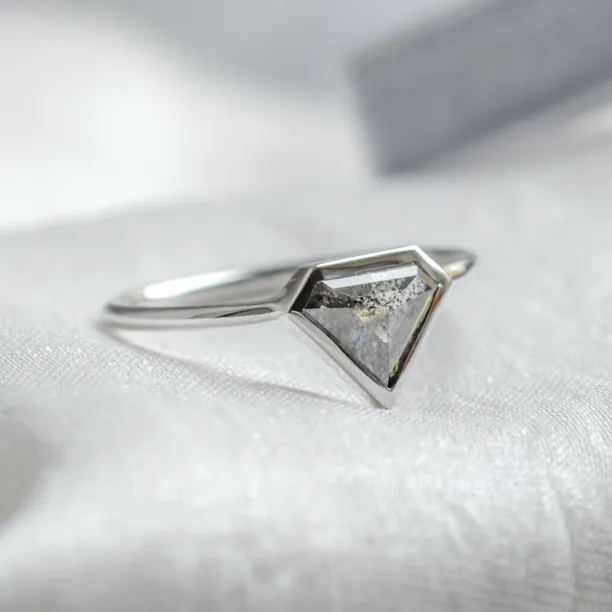 Side-angled view of the HERO gold ring with a superman salt and pepper diamond
