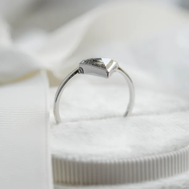 Side view of the HERO gold ring showing its diamond setting