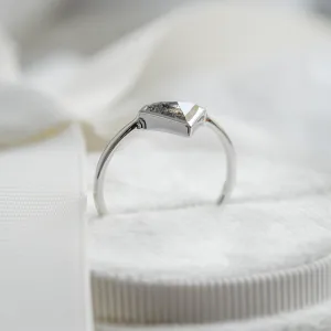 Side view of the HERO gold ring showing its diamond setting