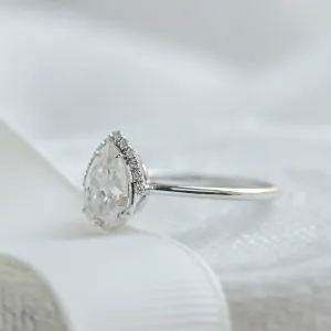 Angled side view of the KIMBER engagement ring setting and pear moissanite